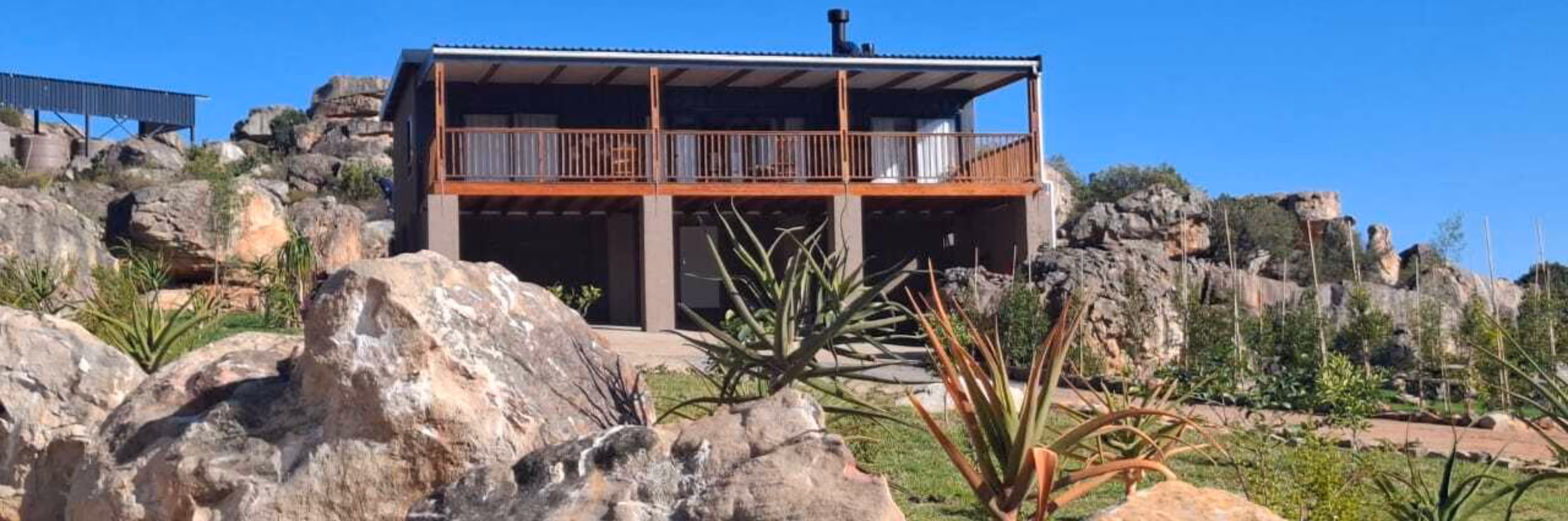 The Walk In built and delivered on the same rocky hillside, deck and balustrade complete