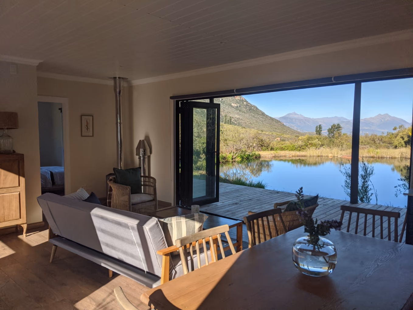 Inside The Independent 3, with folding doors opening to the water and mountains